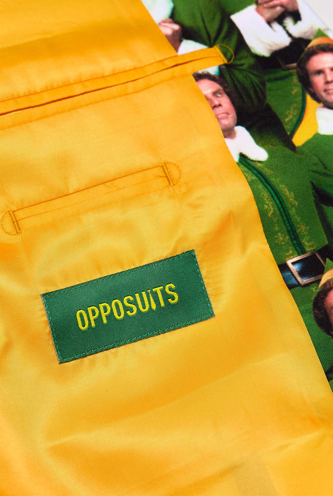 Man wearing men's Christmas suit with the character ELF on the jacket and yellow pants, inside jacket close up