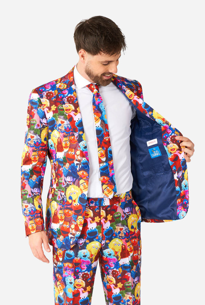 Man wearing men's suit with Sesame street characters print