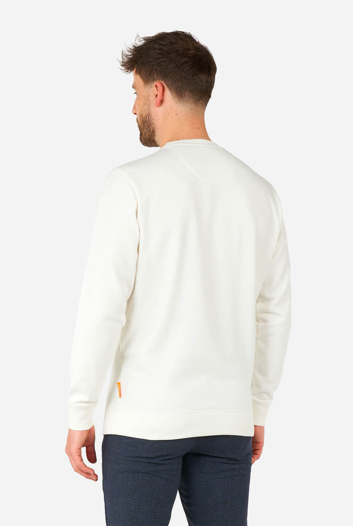 Man wearing white sweater with Elf Christmas image, view from the back.