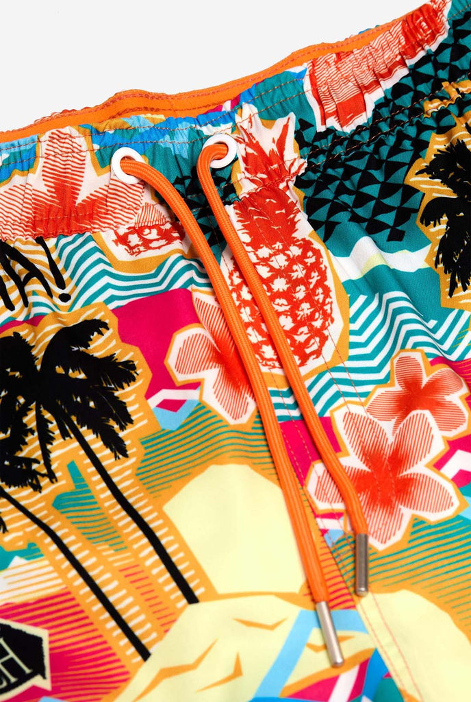 Man wearing swim trunks with tropical Hawaiian print, close up