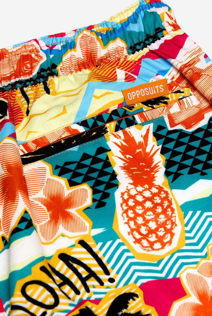 Man wearing swim trunks with tropical Hawaiian print, close up