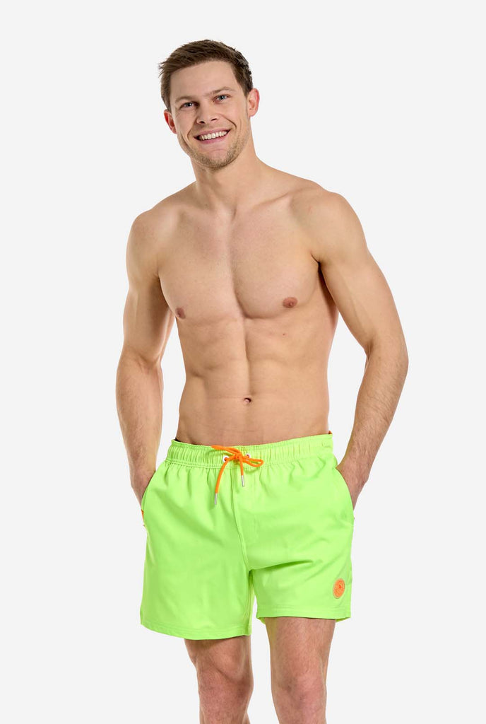 Man wearing Neon lime green swim trunks for men