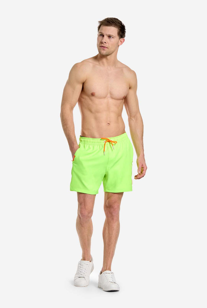 Man wearing Neon lime green swim trunks for men