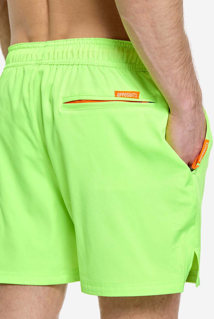 Man wearing Neon lime green swim trunks for men, close up