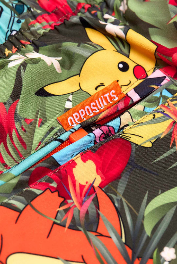 Man wearing swim trunks with Pokemon forest print, close up