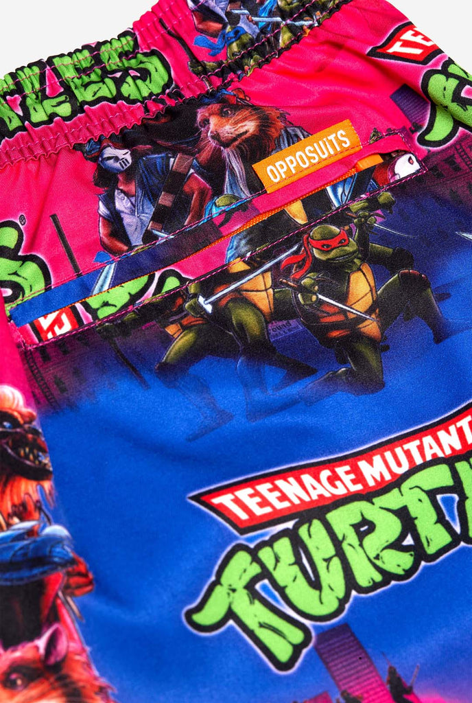 Man wearing TMNT Dude swim trunks for men, close up