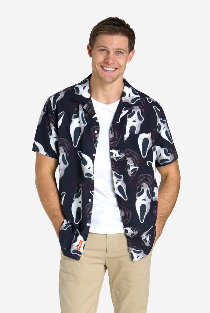 Man wearing black Hawaiian shirt with Ghostface print