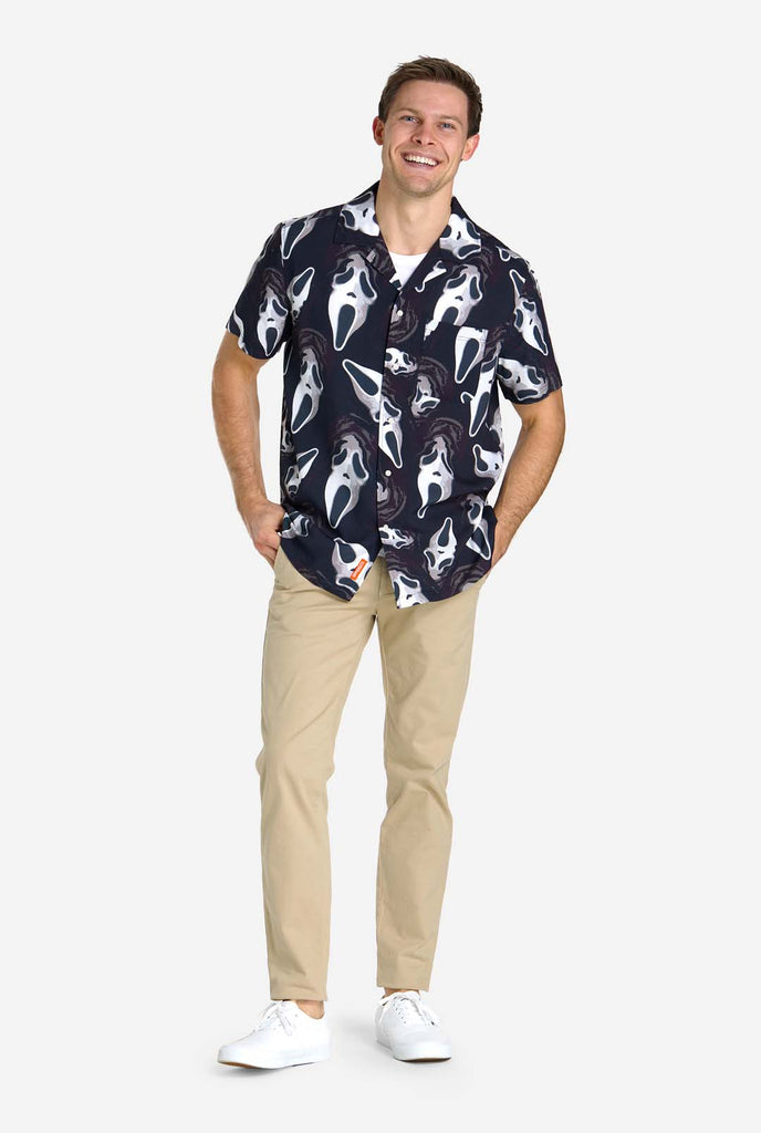 Man wearing black Hawaiian shirt with Ghostface print