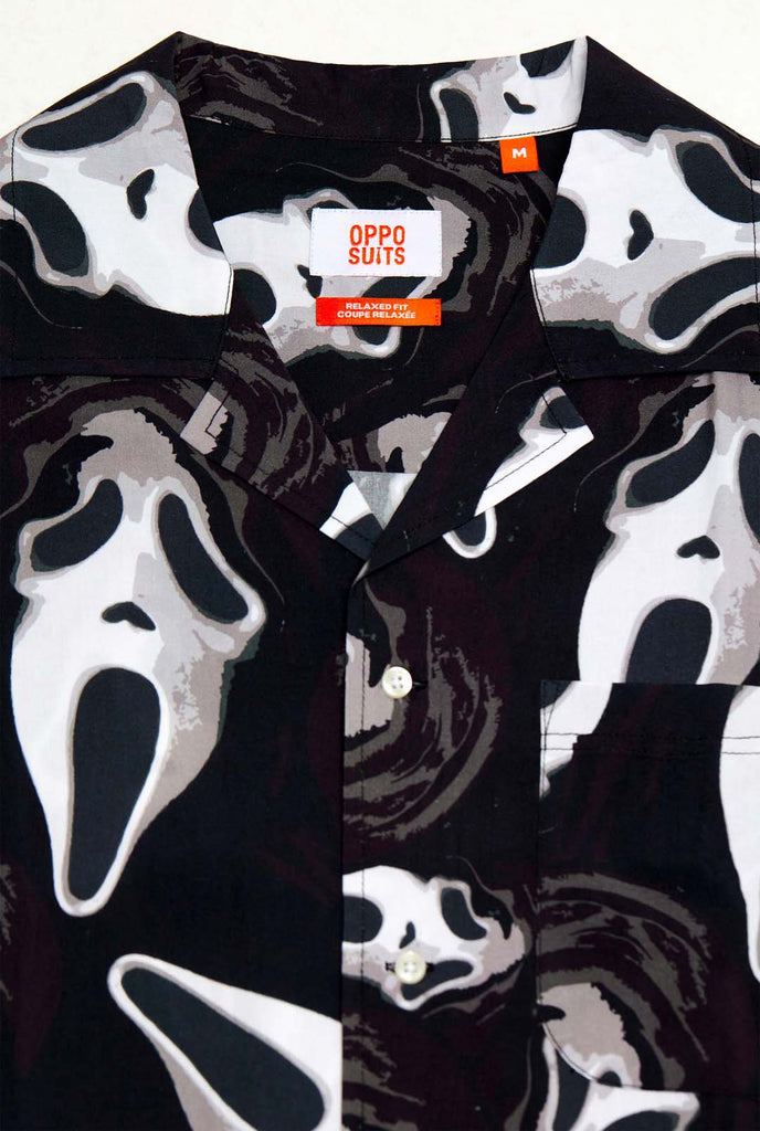 Man wearing black Hawaiian shirt with Ghostface print, close up