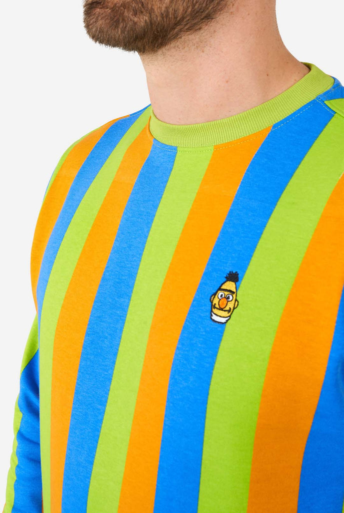 Man wearing Sesame Street Bert style Men's Sweater with green, blue and orange stripes, close up