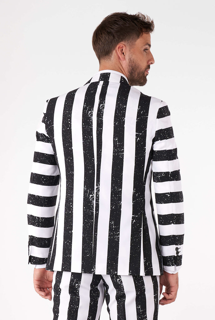 Man wearing striped black and white Beetlejuice men's suit, view from the back