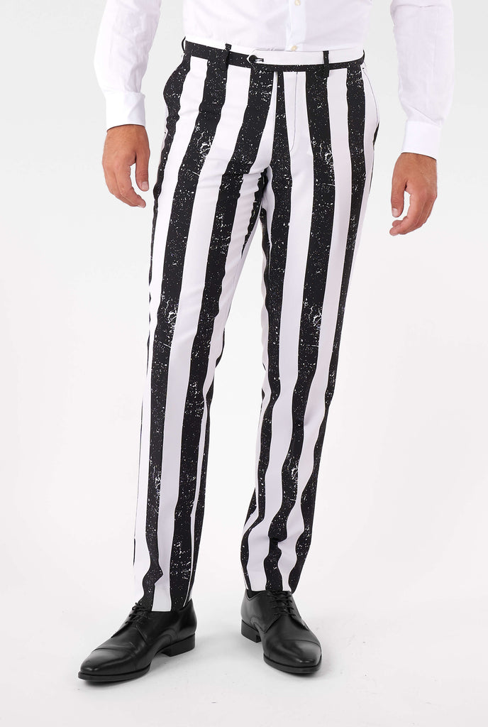 Man wearing striped black and white Beetlejuice men's suit, pants close up