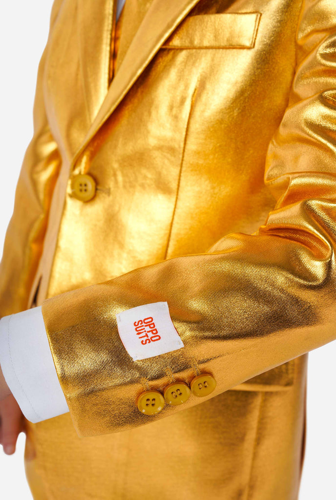 Boy wearing shining groovy gold suit, sleeve close up