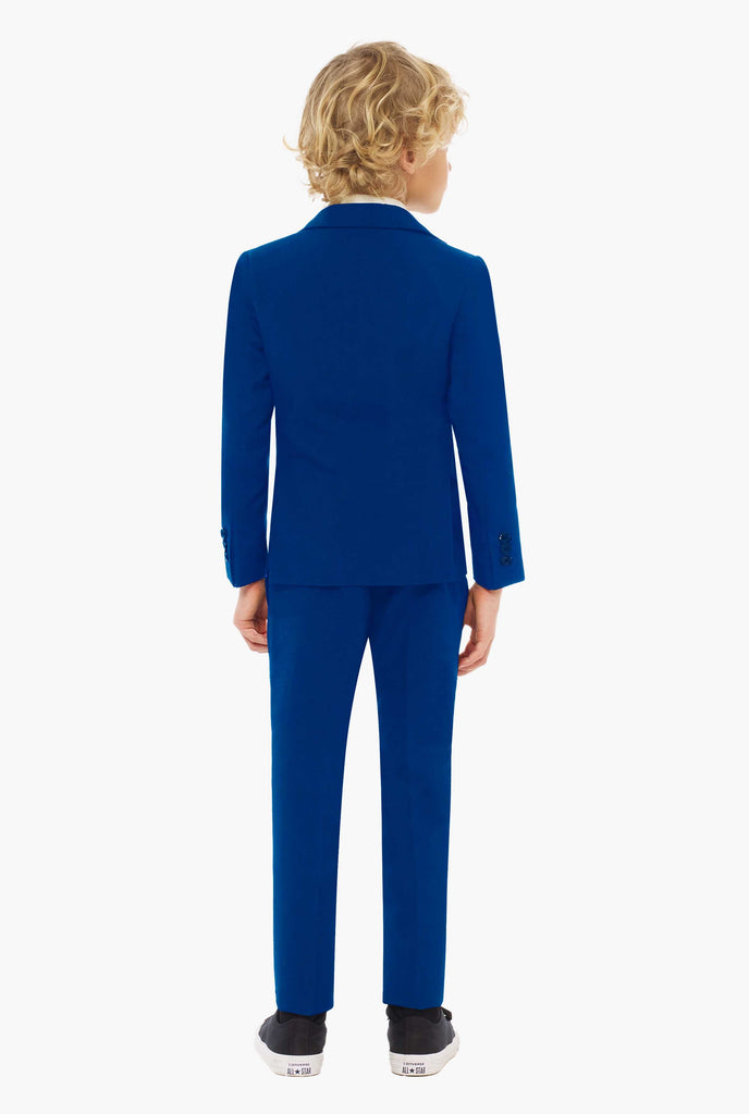 Dark blue suit for boys worn by boy from the back