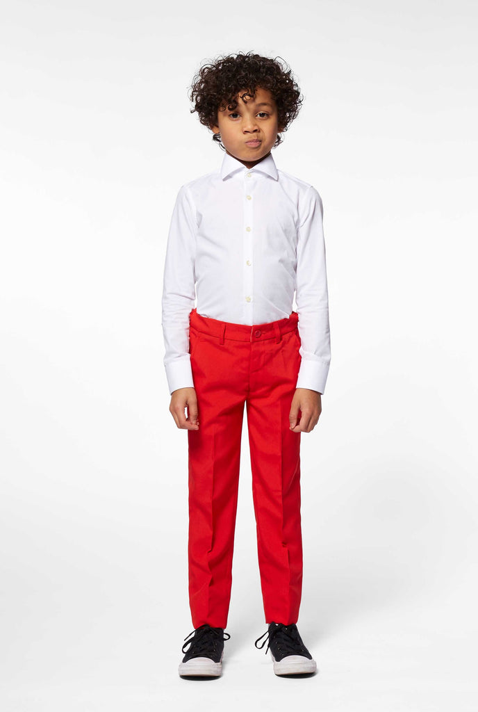 Red suit for boys worn by boy, view of pants