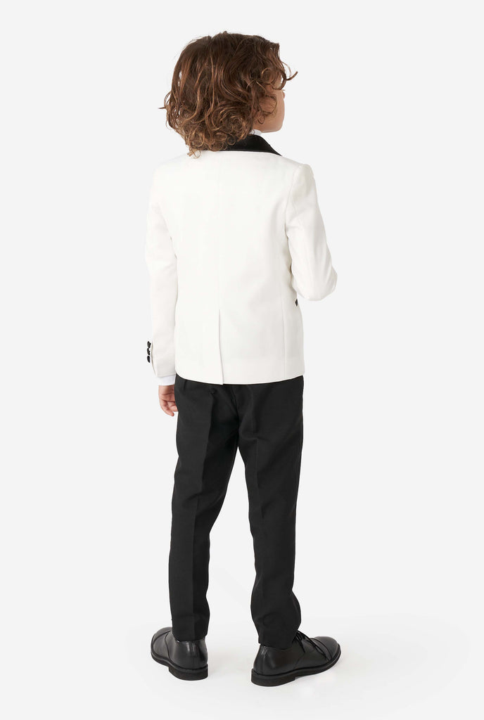 Kid wearing white and black tuxedo, view from the back