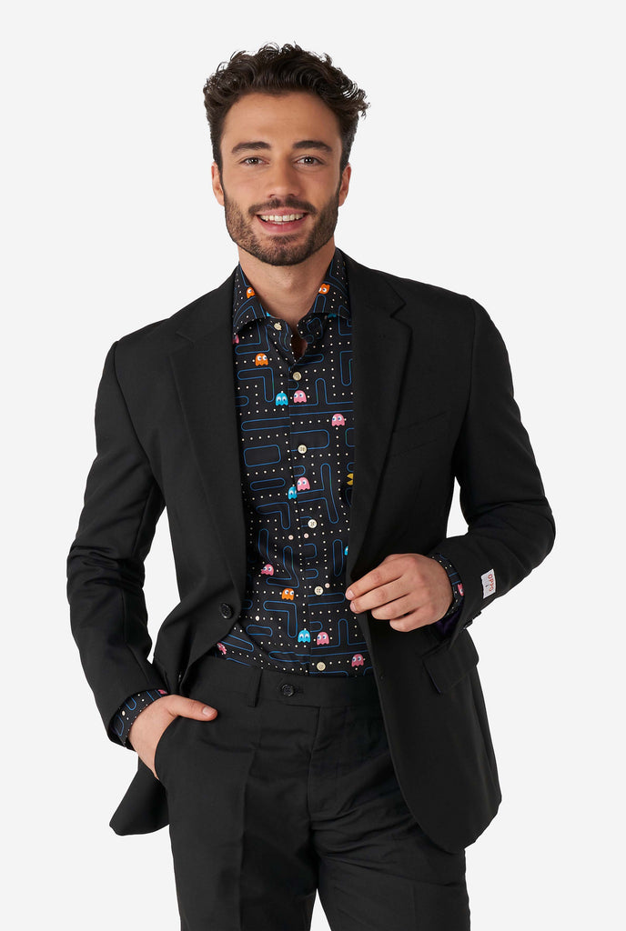 Man wearing black dress shirt with Pac-Man print and black men's suit