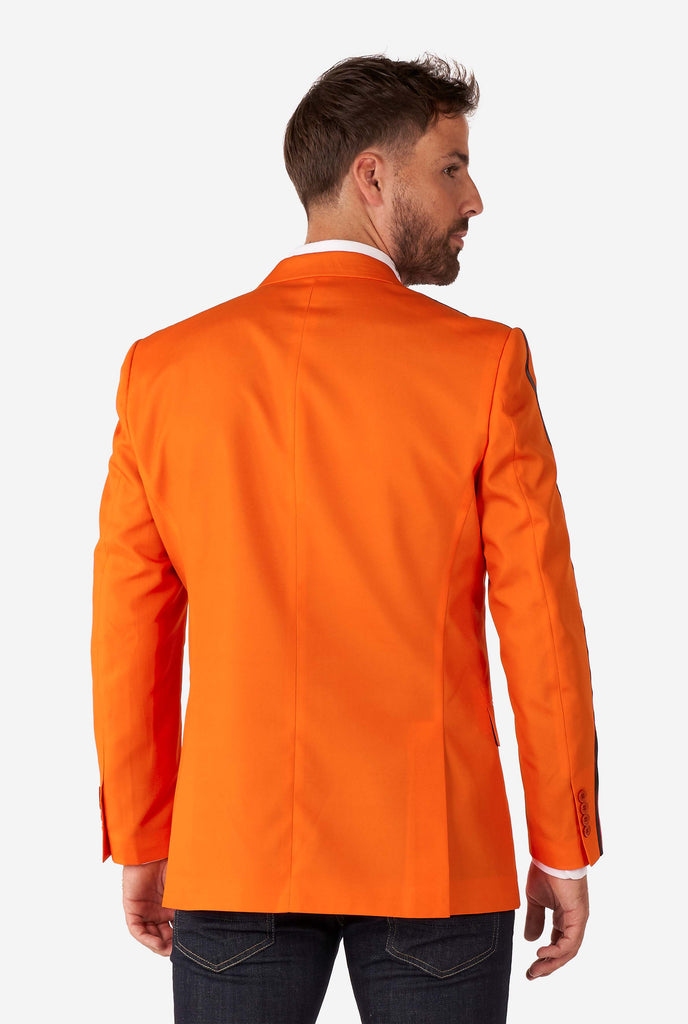 Man wearing orange blazer with dutch lion, view from the back