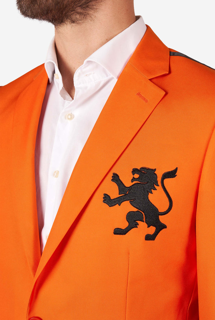 Man wearing orange blazer with dutch lion, close up