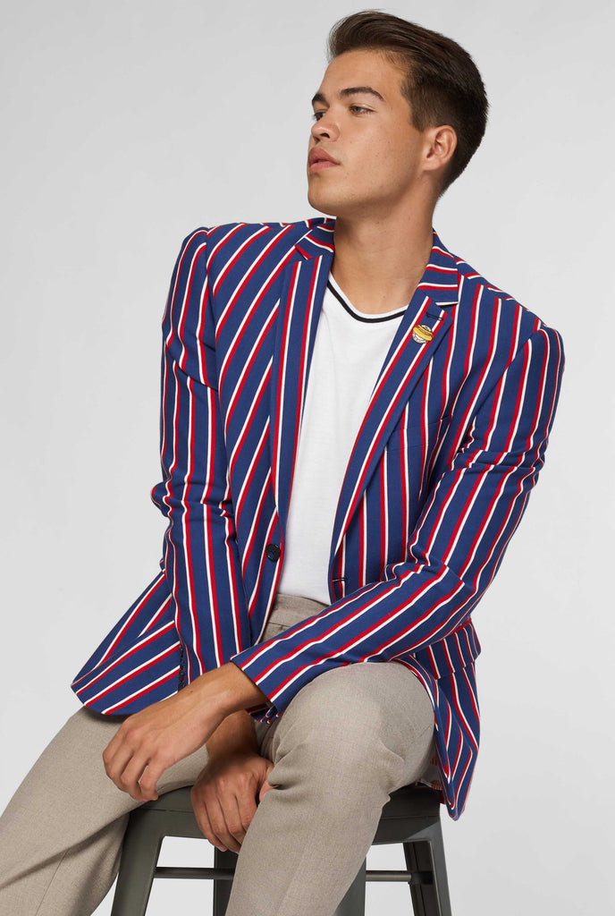 Red white and blue striped casual blazer worn by man sitting on stool