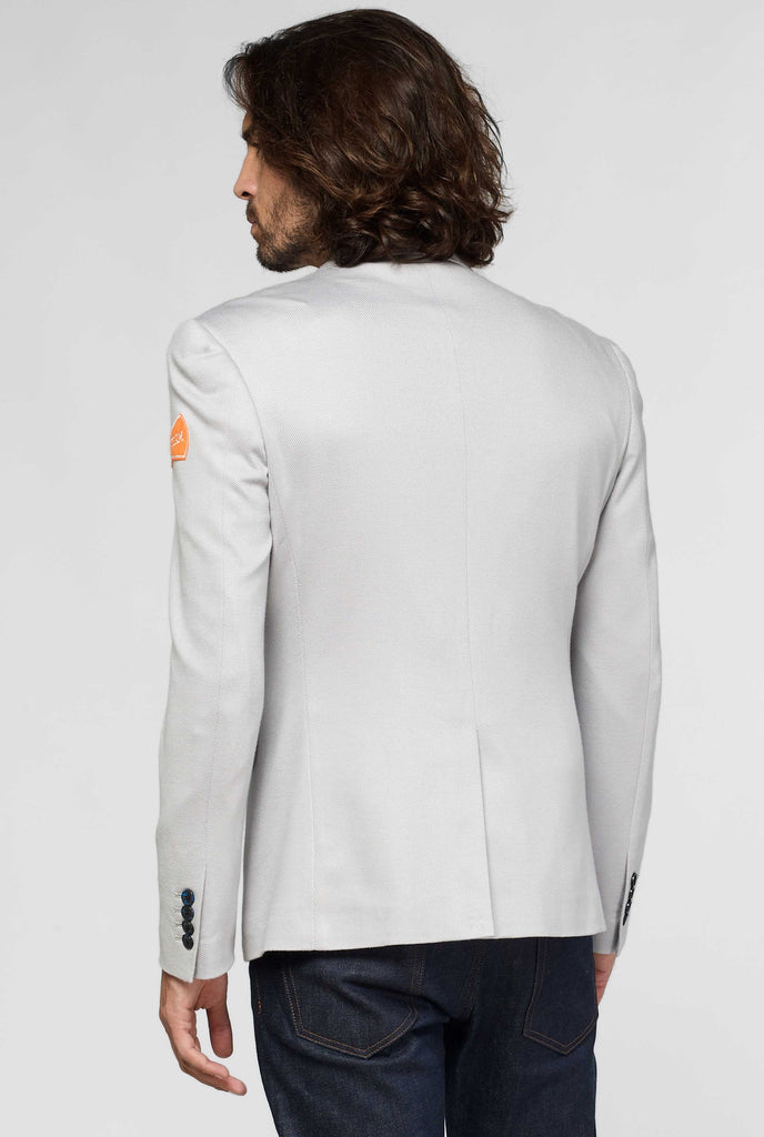 Grey sportswear blazer with sports patches worn by man shown from behind