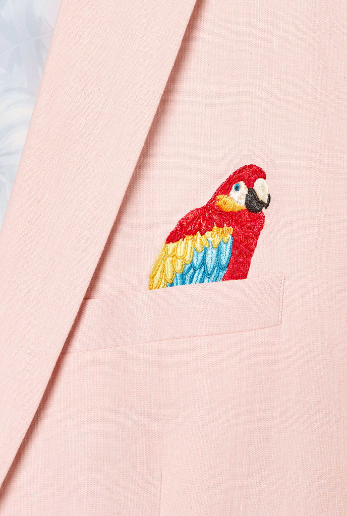 Pink blazer with parrot embroidery worn by man showing embroidery detail