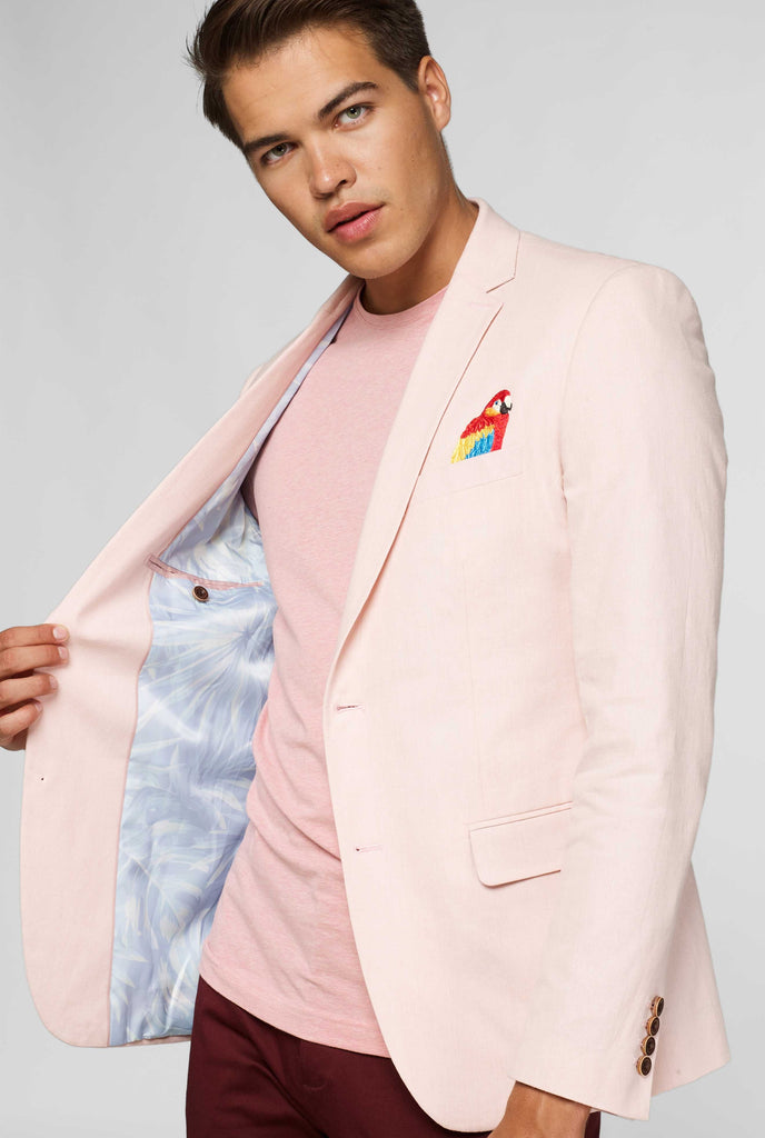 Pink blazer with parrot embroidery worn by man showing inside of jacket