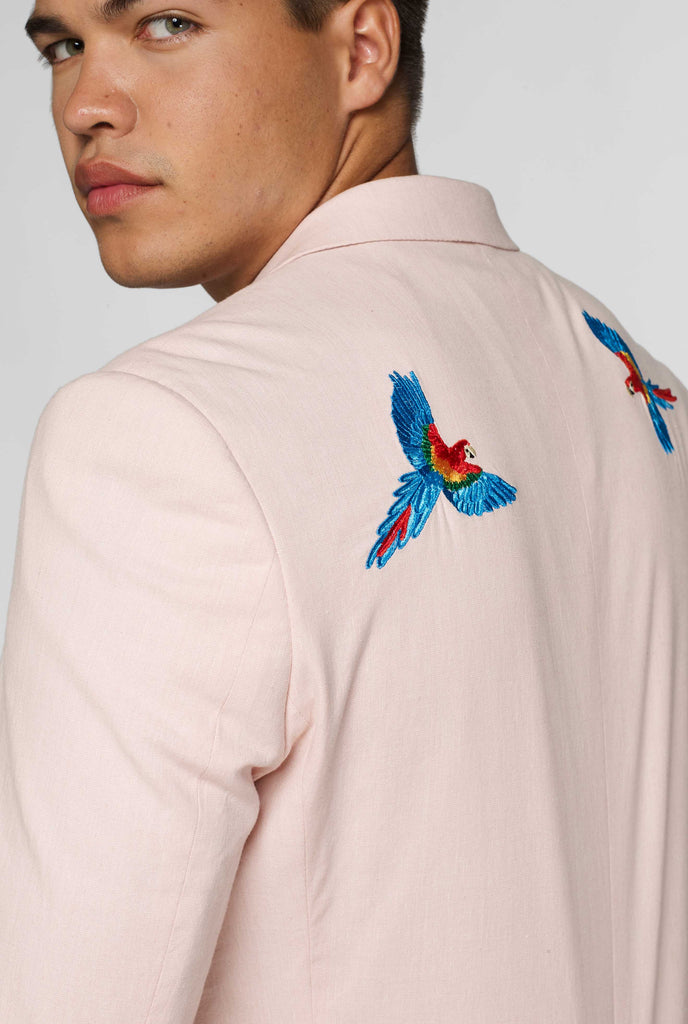 Pink blazer with parrot embroidery worn by man showing shoulder detail