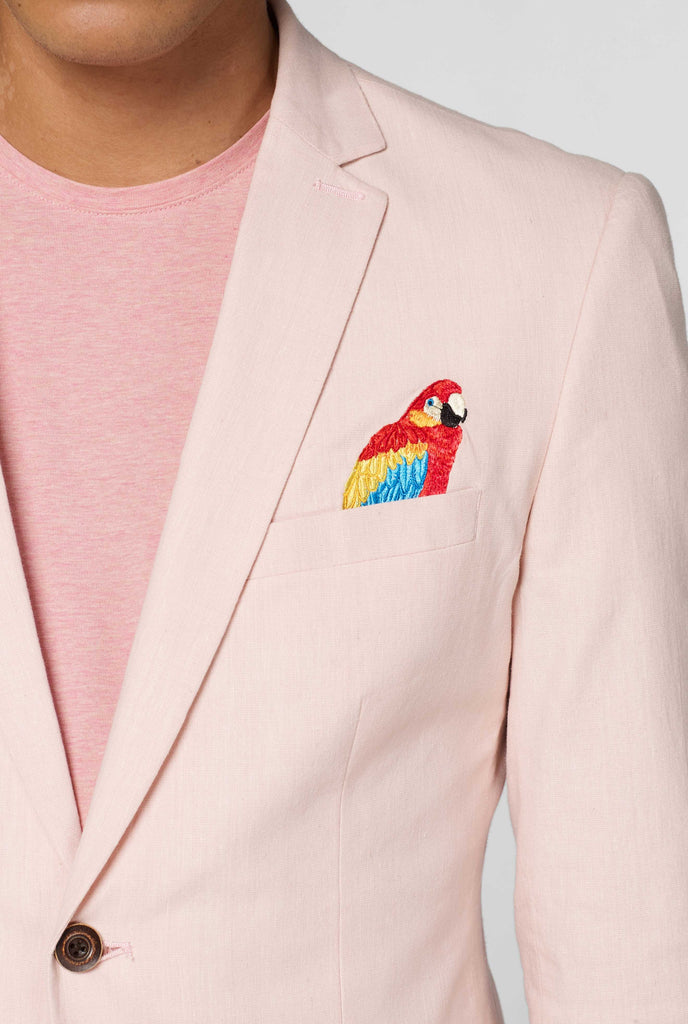 Pink blazer with parrot embroidery worn by man showing embroidery detail