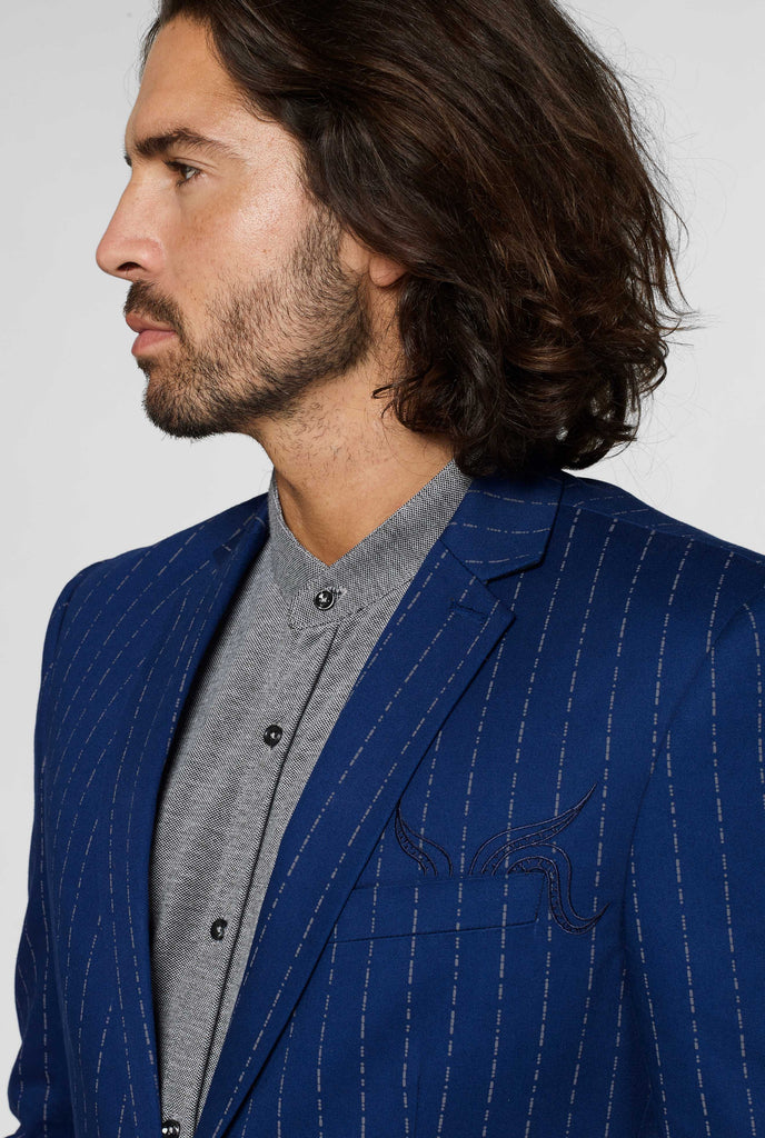 Navy blue captain style pinstripe blazer worn by man shown from the side