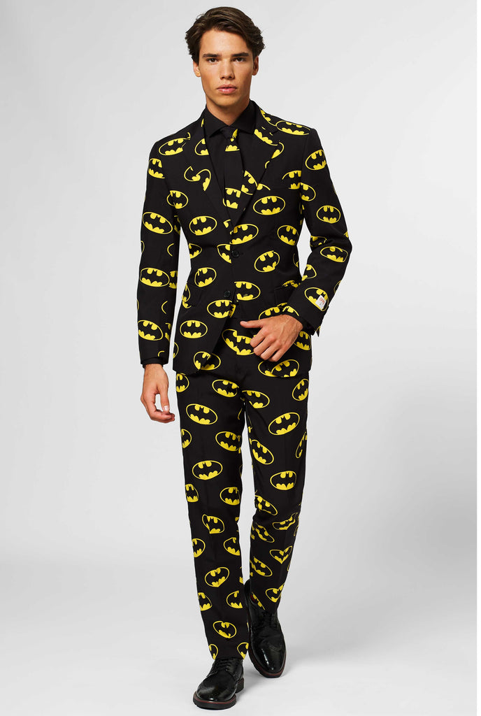 Black men's suit with Batman logos print worn by man