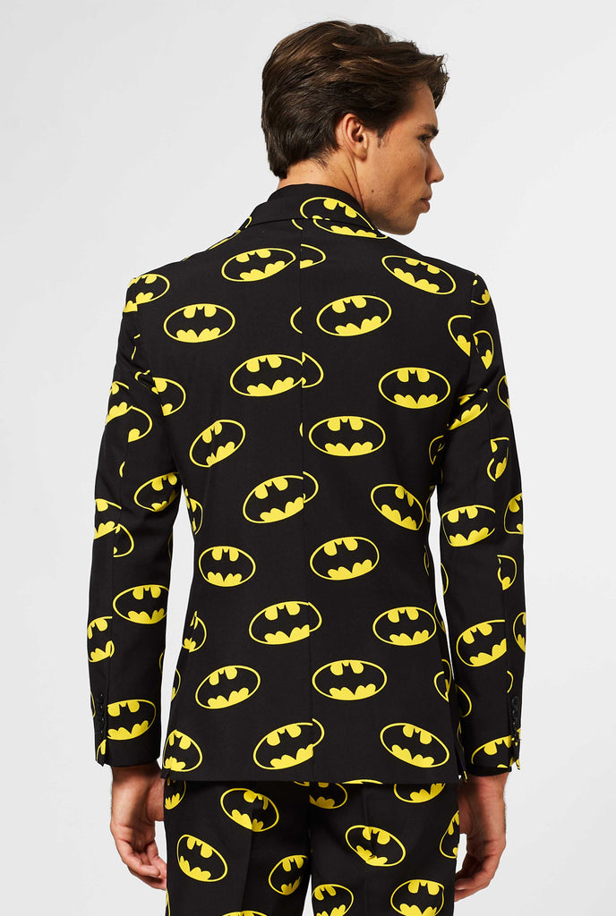 Black men's suit with Batman logos print worn by man shown from back