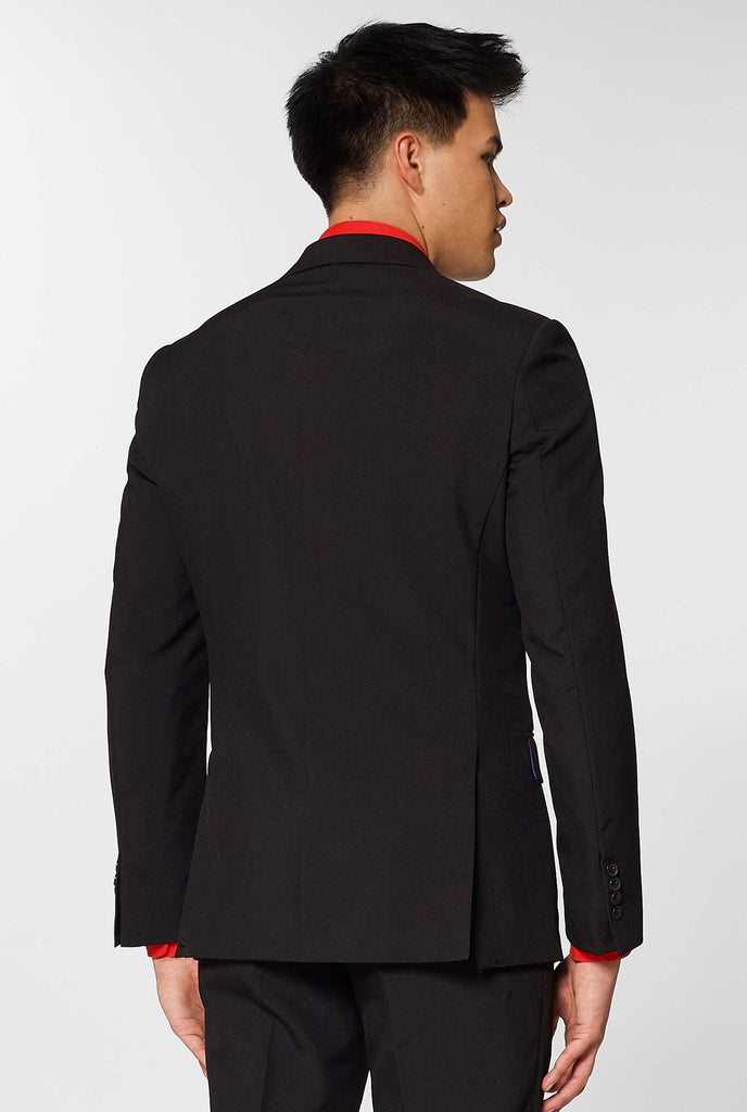 All black suit worn by man showing back