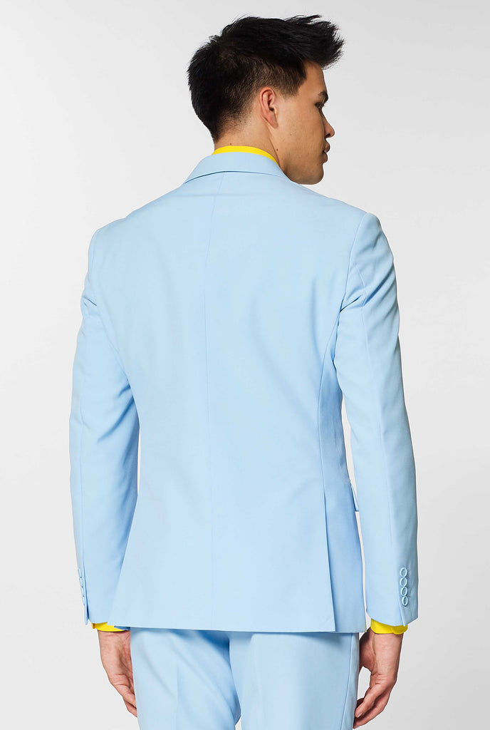 Man wearing light blue men's suit and yellow dress shirt