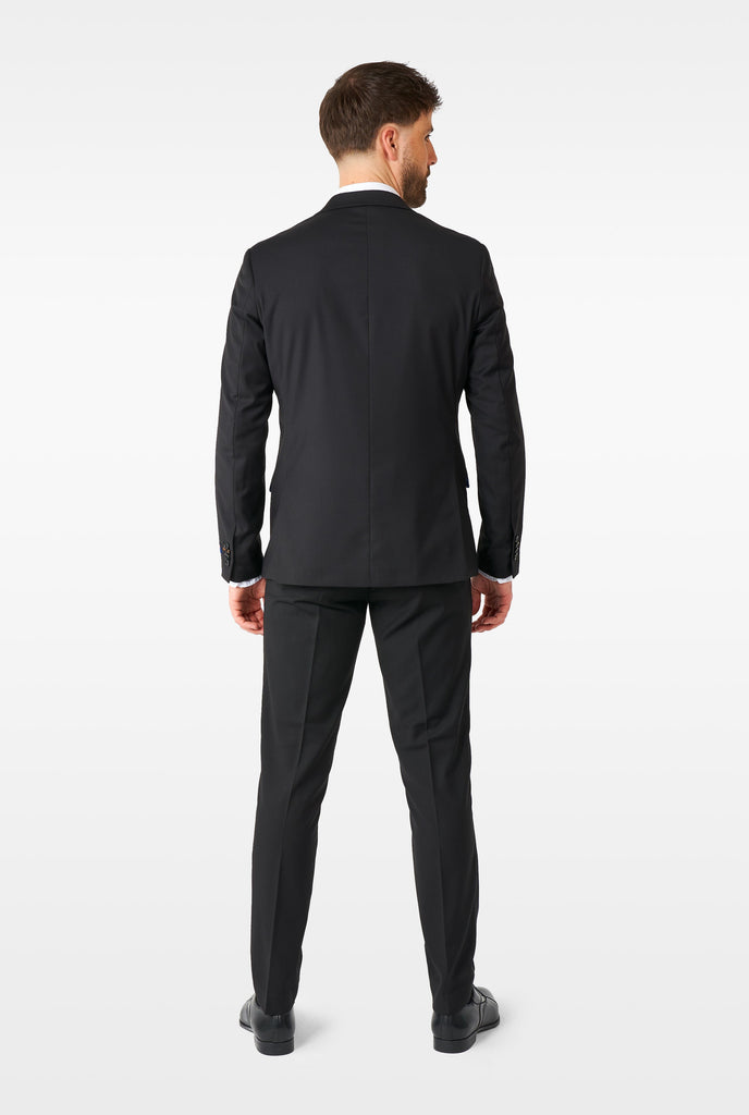 Man wearing casual black business suit, view from the back