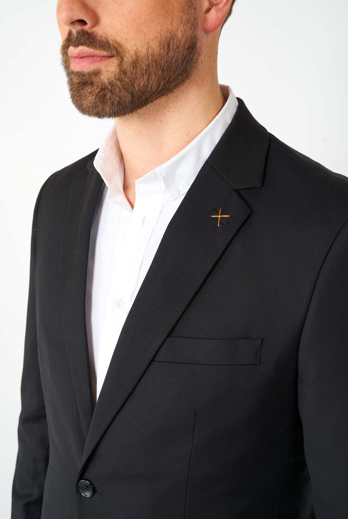 Man wearing casual black business suit, close up