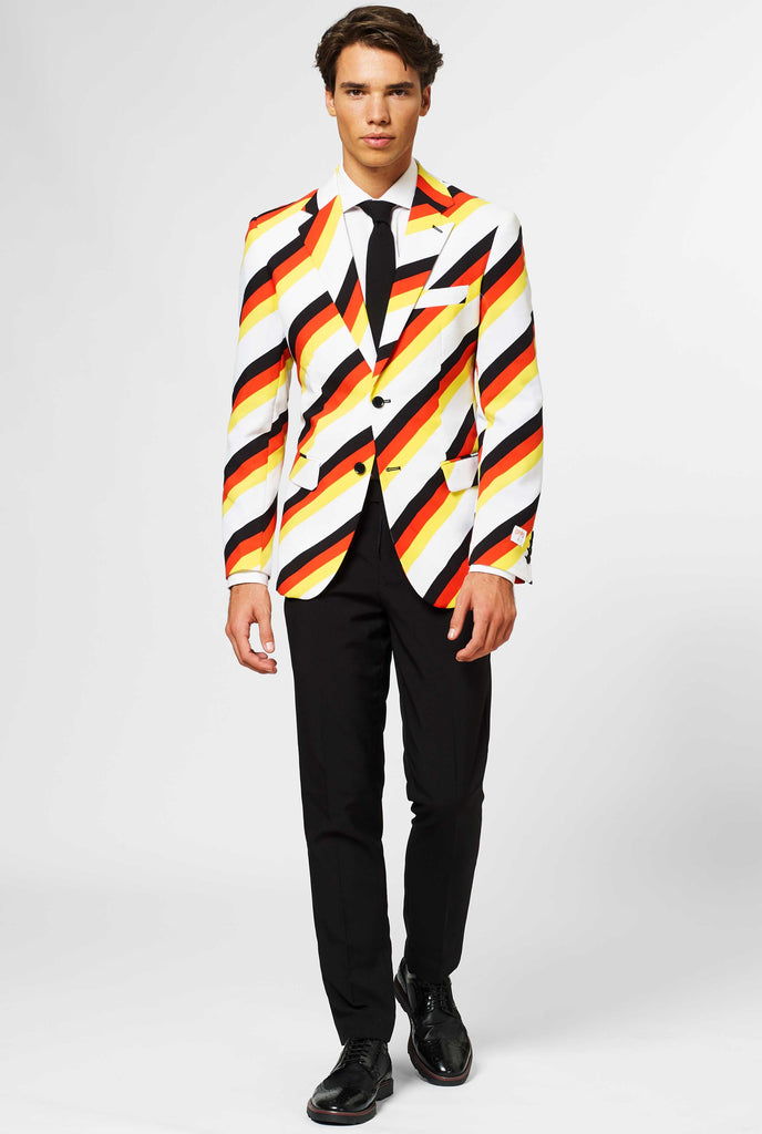Man wearing German flag colored suit