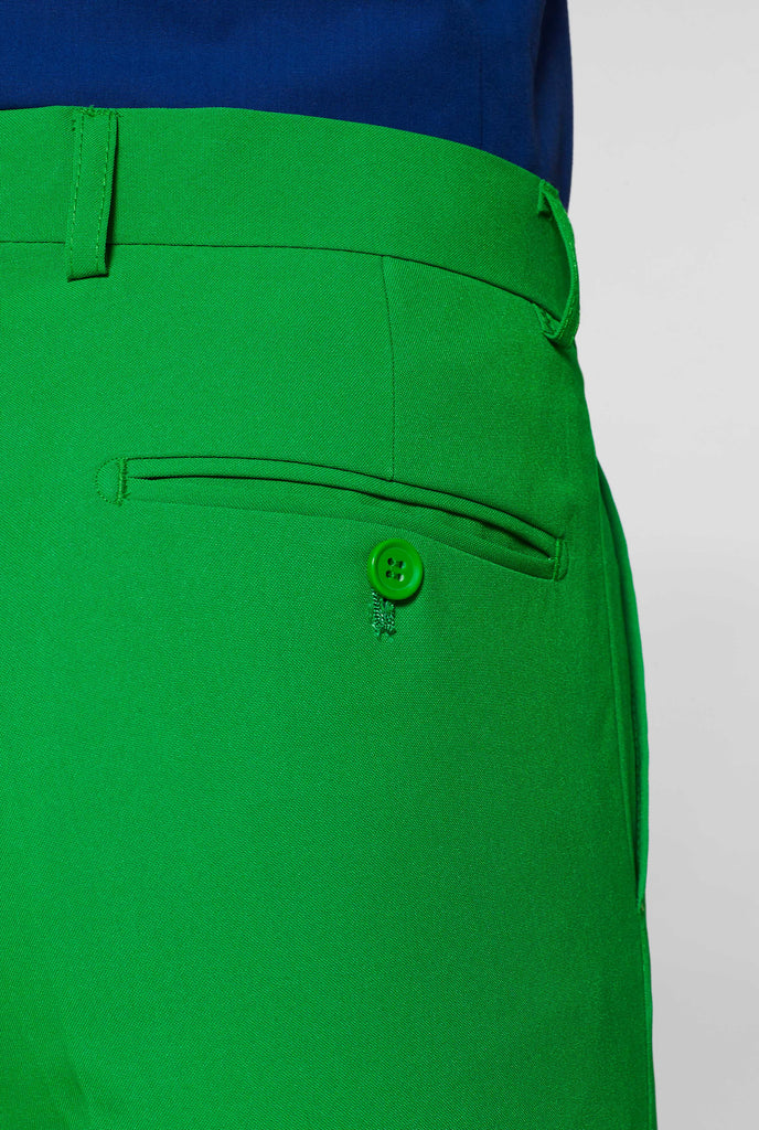 Man wearing green men's suit and dark blue dress shirt, pants close up