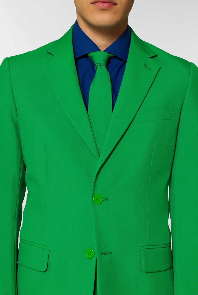 Man wearing green men's suit and dark blue dress shirt, close up