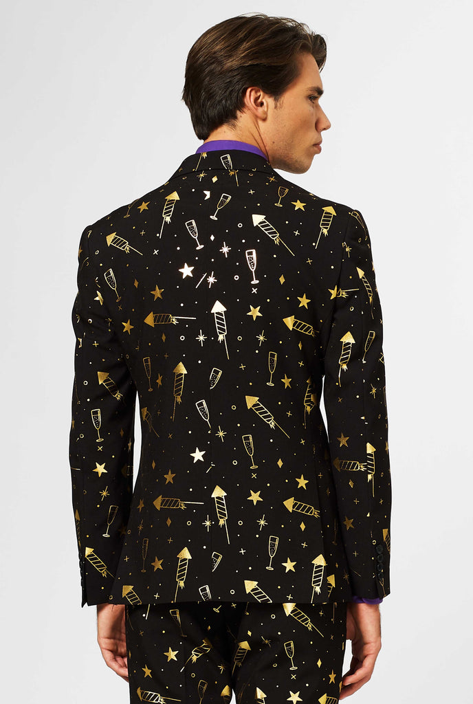 Black men's suit with golden fireworks print worn by man, view from the back