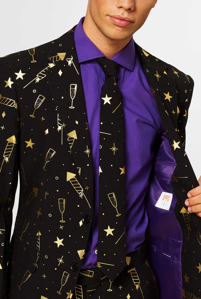 Black men's suit with golden fireworks print worn by man, showing inside the jacket