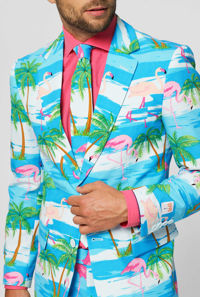 Blue and white suit with tropical flamingo print Flaminguy worn by man up close jacket