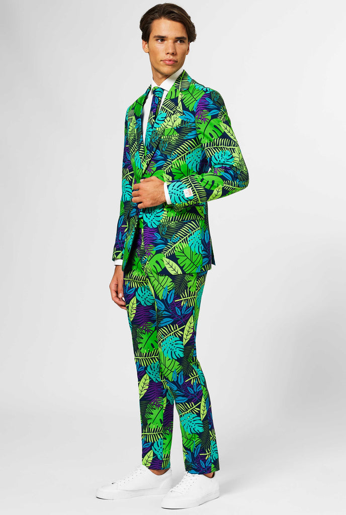 Jungle print men's suit with green and purple leaf print worn by man