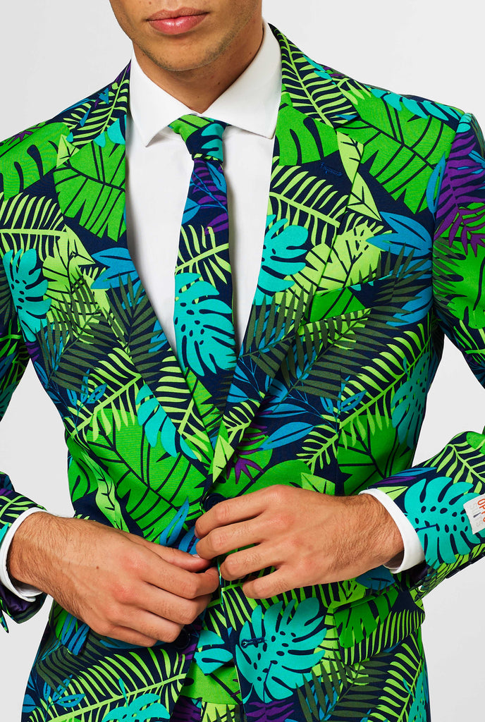 Jungle print men's suit with green and purple leaf print worn by man