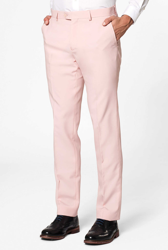 Man wearing pastel pink colored men's suit, pants close up