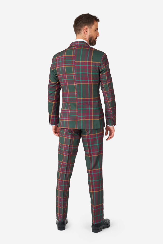 Man wearing a tartan plaid Christmas suit, view from the back