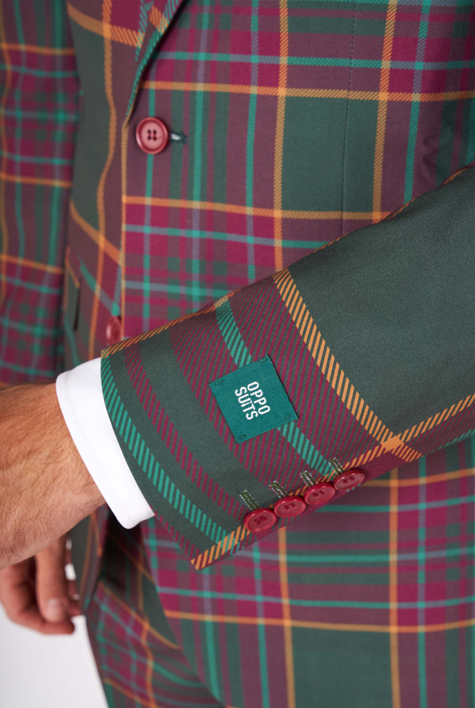 Man wearing a tartan plaid Christmas suit, close up sleeve