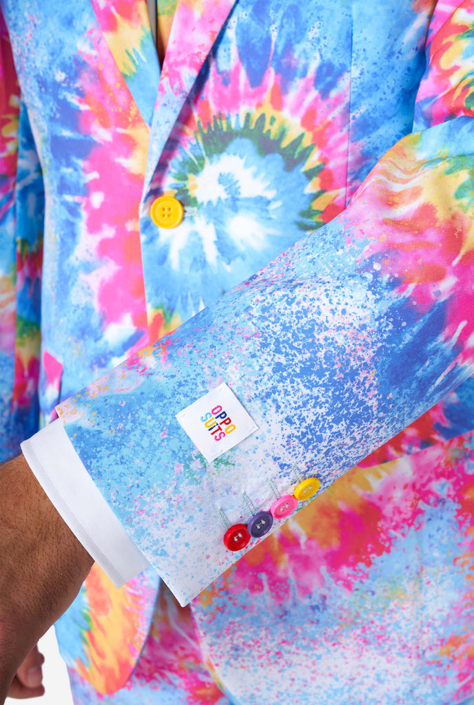 Man wearing pride men's suit with colorful tie dye rainbow print, close up