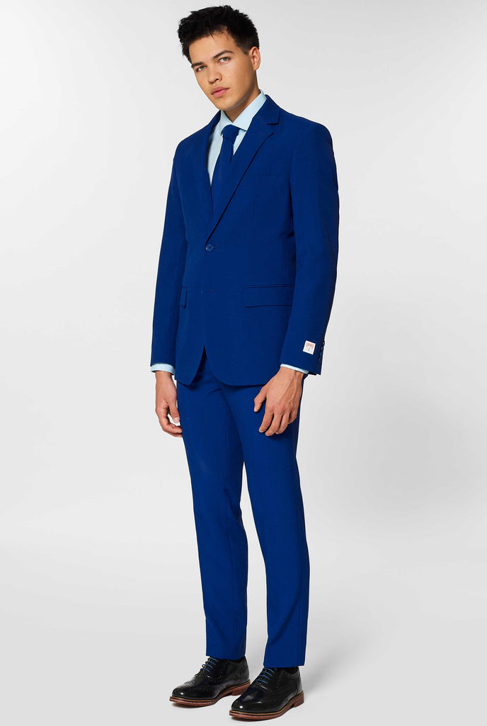 Navy blue solid colored men's suit worn by man