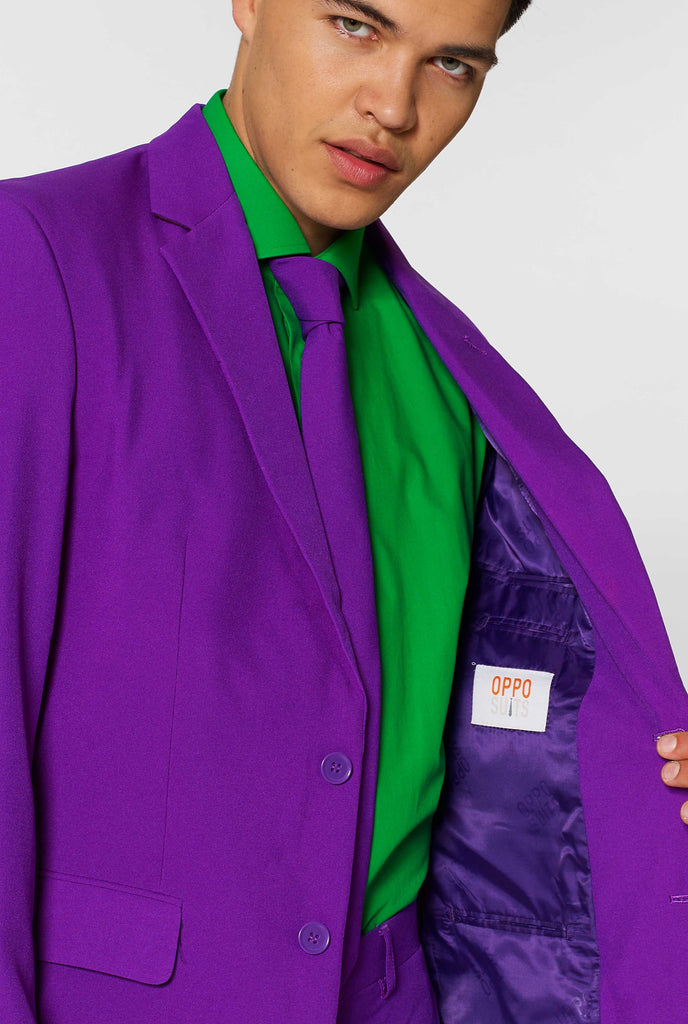 Man wearing purple men's suit and green dress shirt, close up